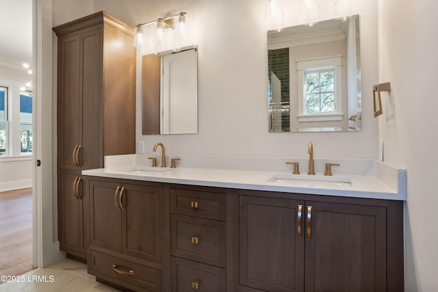 bathroom with crown molding, vanity, tile patterned flooring, and a wealth of natural light