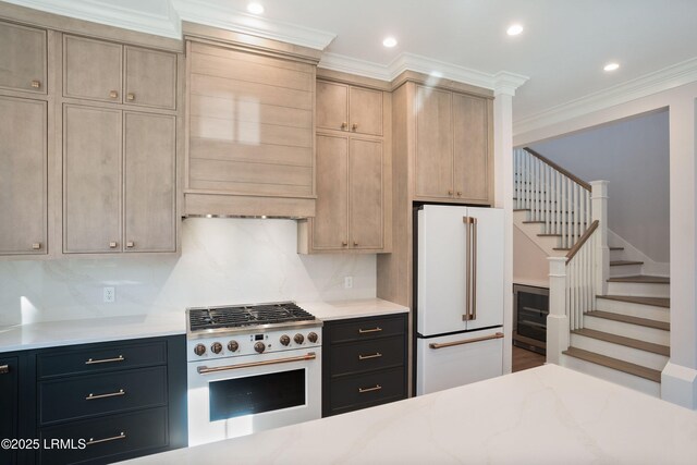 kitchen with stove, decorative backsplash, light brown cabinets, and white refrigerator