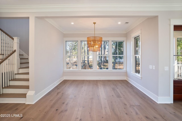 unfurnished dining area with crown molding, plenty of natural light, and light wood-type flooring