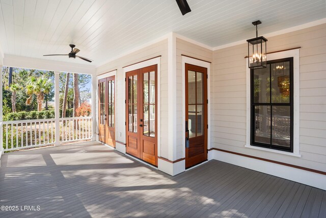 unfurnished sunroom with wood ceiling and ceiling fan with notable chandelier