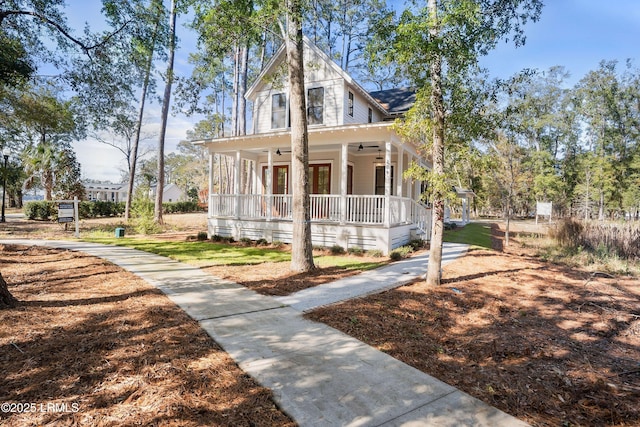 farmhouse-style home with ceiling fan and covered porch