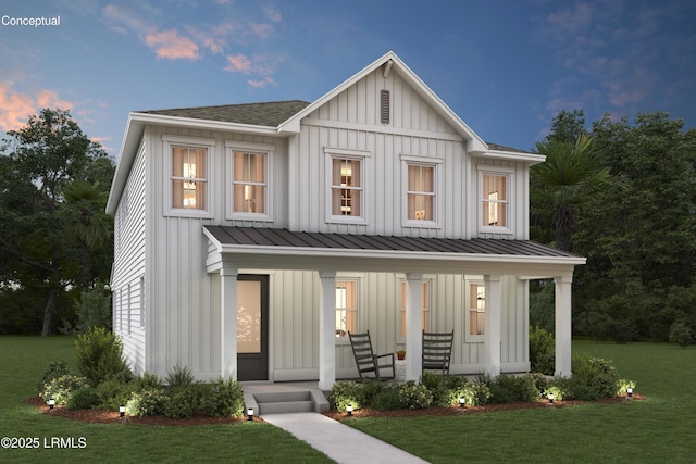 modern farmhouse featuring roof with shingles, covered porch, a standing seam roof, a yard, and board and batten siding