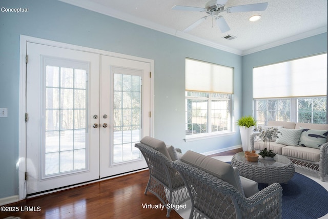 sunroom with ceiling fan and french doors