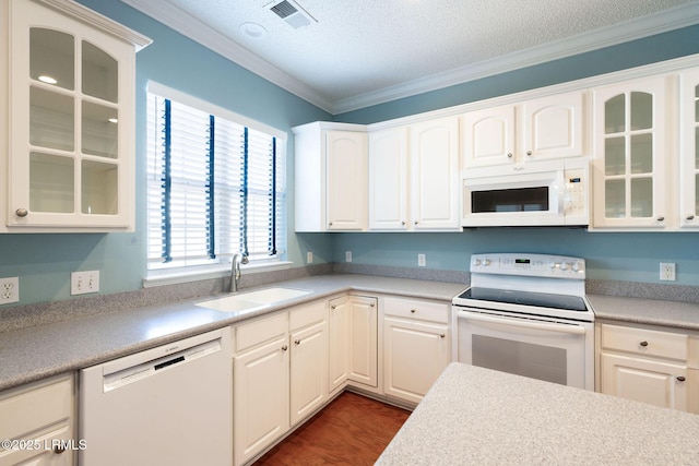 kitchen featuring white cabinetry, sink, white appliances, crown molding, and a textured ceiling