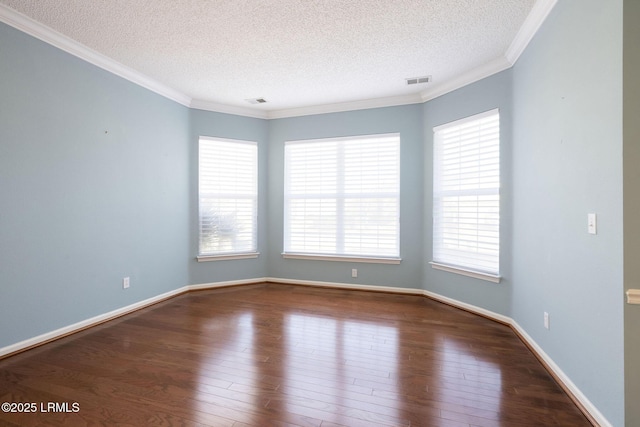 spare room with ornamental molding, hardwood / wood-style floors, and a textured ceiling