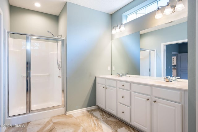 bathroom featuring walk in shower and vanity