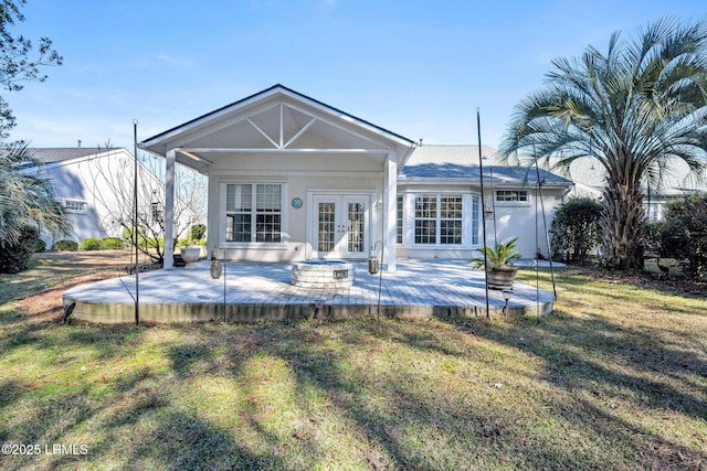 back of house with a yard, a patio area, and french doors