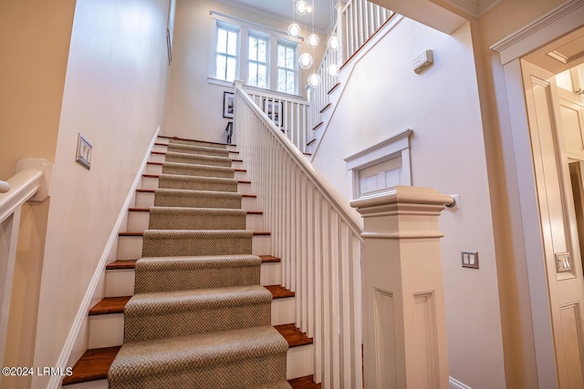 staircase featuring ornamental molding