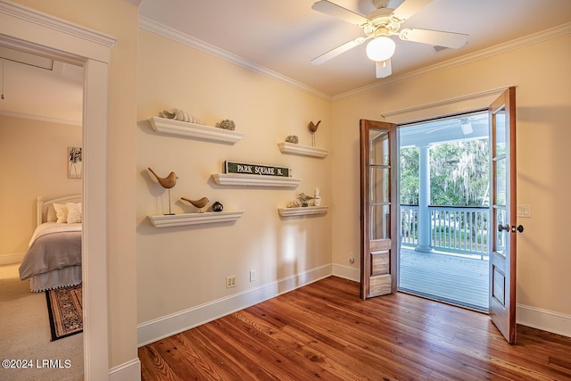 entryway with crown molding, ceiling fan, and wood-type flooring