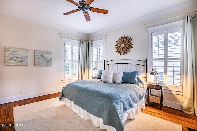 bedroom featuring ornamental molding, hardwood / wood-style floors, and ceiling fan