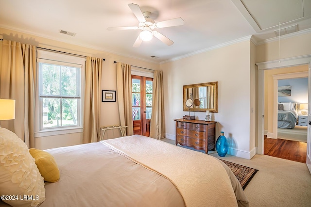 bedroom featuring ceiling fan, ornamental molding, carpet floors, and multiple windows