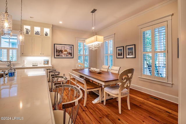 dining area featuring crown molding and dark hardwood / wood-style floors