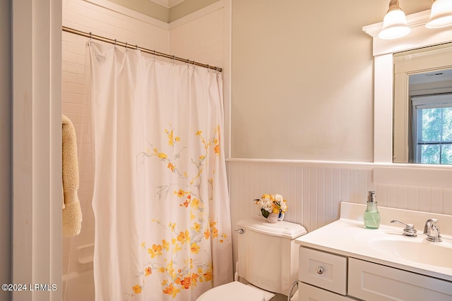 bathroom featuring vanity, walk in shower, and toilet