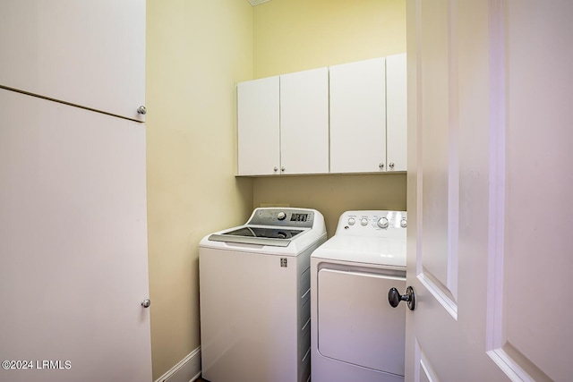 washroom with cabinets and separate washer and dryer