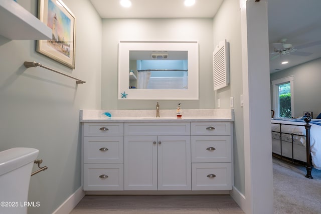 bathroom with recessed lighting, toilet, vanity, a shower with curtain, and baseboards