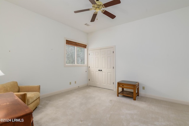 sitting room featuring ceiling fan and light carpet