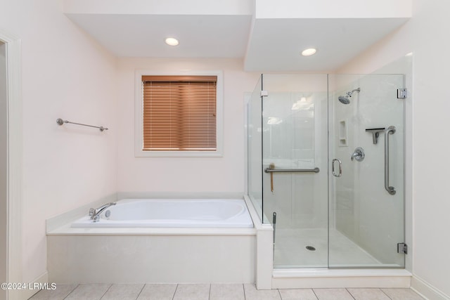 bathroom featuring tile patterned flooring and separate shower and tub