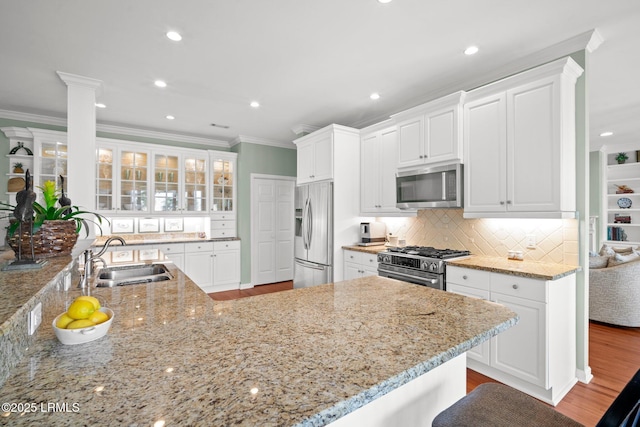 208 Cotton Dike Rd, Saint Helena Island, SC 29920 - kitchen featuring stainless steel appliances, a sink, crown molding, white cabinetry, and light stone countertops