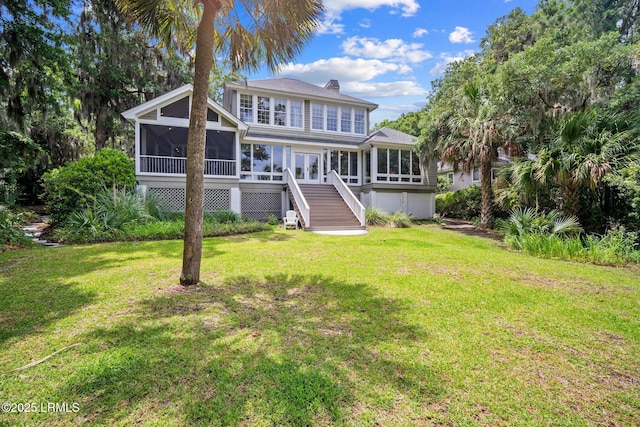 208 Cotton Dike Rd, Saint Helena Island, SC 29920 - view of front facade featuring a sunroom, stairs, a front lawn, a chimney, and roof with shingles