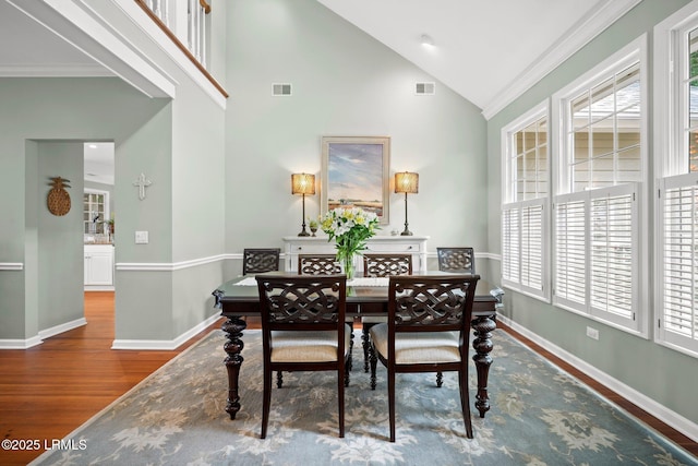 208 Cotton Dike Rd, Saint Helena Island, SC 29920 - dining room featuring wood finished floors, crown molding, baseboards, and high vaulted ceiling