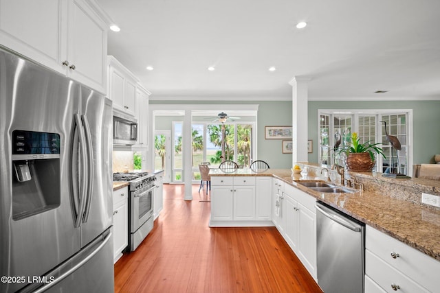 208 Cotton Dike Rd, Saint Helena Island, SC 29920 - kitchen featuring stainless steel appliances, a sink, ceiling fan, white cabinetry, and crown molding