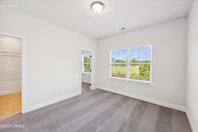 unfurnished bedroom with baseboards, visible vents, and carpet flooring