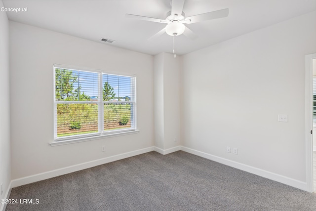 carpeted empty room featuring visible vents, ceiling fan, and baseboards