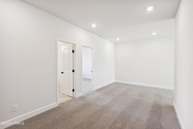 spare room with carpet floors, recessed lighting, and baseboards