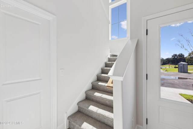 stairs featuring plenty of natural light