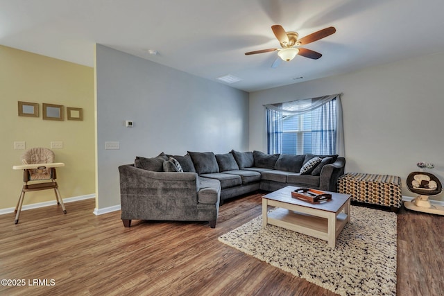 living room featuring hardwood / wood-style flooring and ceiling fan