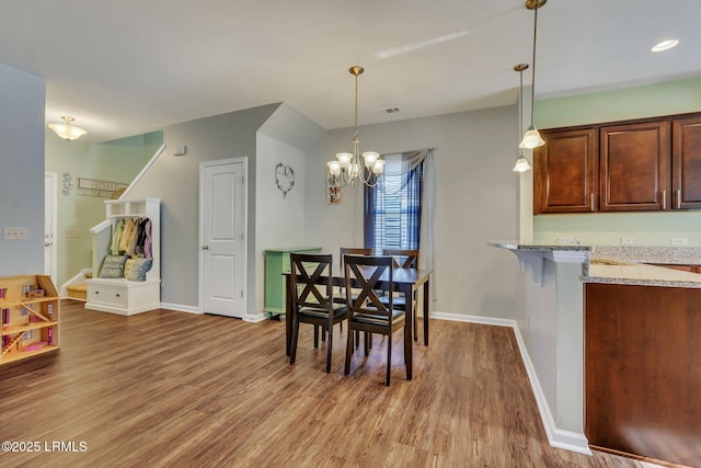 dining room featuring an inviting chandelier and wood-type flooring