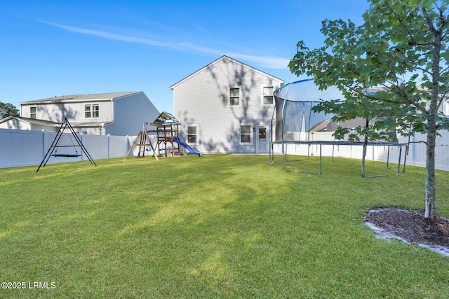 view of yard with a playground and a trampoline