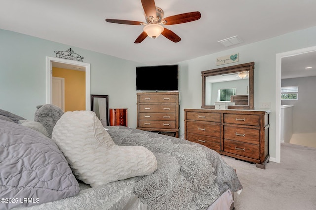 bedroom featuring light carpet and ceiling fan