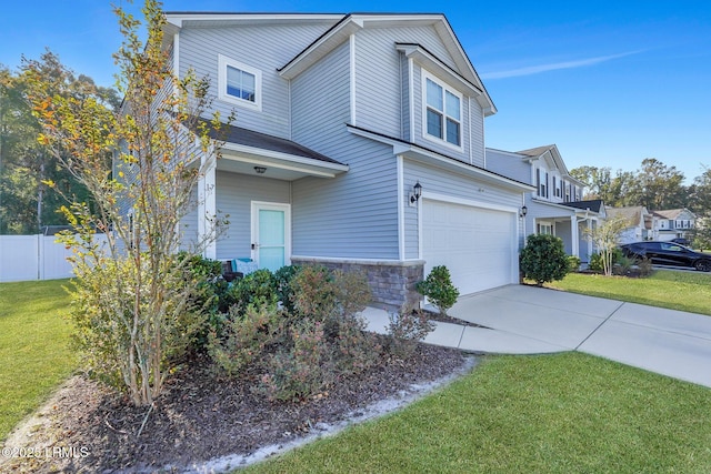 view of front of house featuring a garage and a front yard