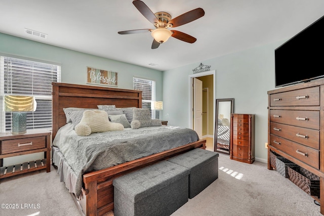 bedroom featuring light colored carpet and ceiling fan