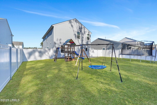 view of yard with a playground and a trampoline