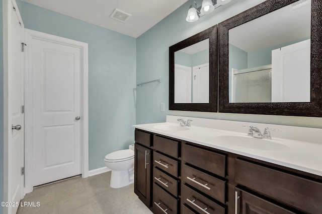 bathroom featuring vanity, an enclosed shower, and toilet