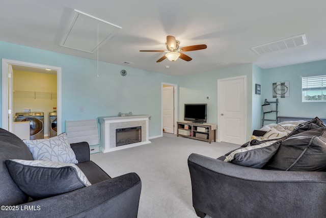 carpeted living room featuring washing machine and dryer