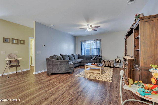 living room featuring ceiling fan and dark hardwood / wood-style floors