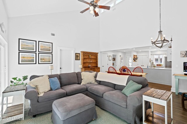 12 Harvest Ln, Beaufort, SC 29907 - living area with high vaulted ceiling, ceiling fan with notable chandelier, baseboards, wood finished floors, and visible vents
