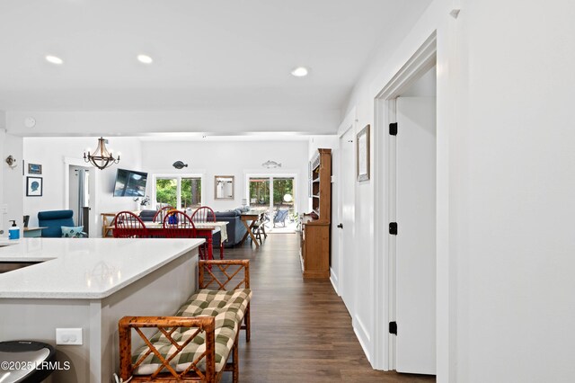 12 Harvest Ln, Beaufort, SC 29907 - kitchen featuring light stone counters, dark wood-style floors, open floor plan, an inviting chandelier, and recessed lighting