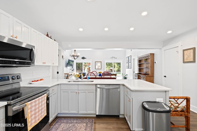 12 Harvest Ln, Beaufort, SC 29907 - kitchen featuring dark wood-style flooring, a sink, light countertops, a peninsula, and stainless steel appliances
