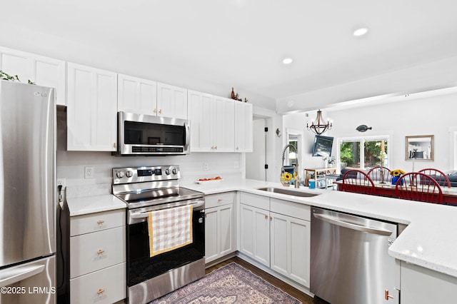 12 Harvest Ln, Beaufort, SC 29907 - kitchen featuring recessed lighting, white cabinets, a sink, a notable chandelier, and stainless steel appliances