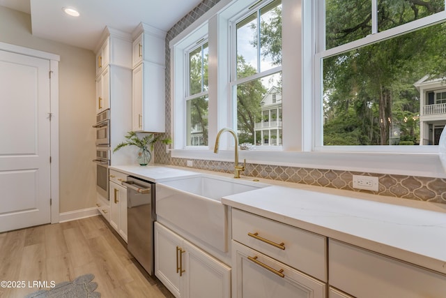 39 Wrights Point Cir, Beaufort, SC 29902 - kitchen with dishwasher, light wood finished floors, white cabinetry, decorative backsplash, and recessed lighting