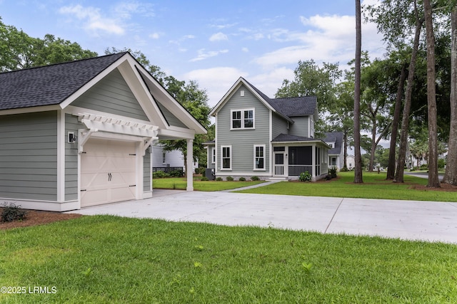 39 Wrights Point Cir, Beaufort, SC 29902 - view of front of home with roof with shingles, concrete driveway, a front yard, and a sunroom