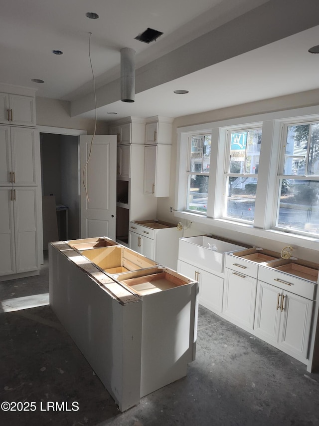 kitchen featuring a center island and white cabinets