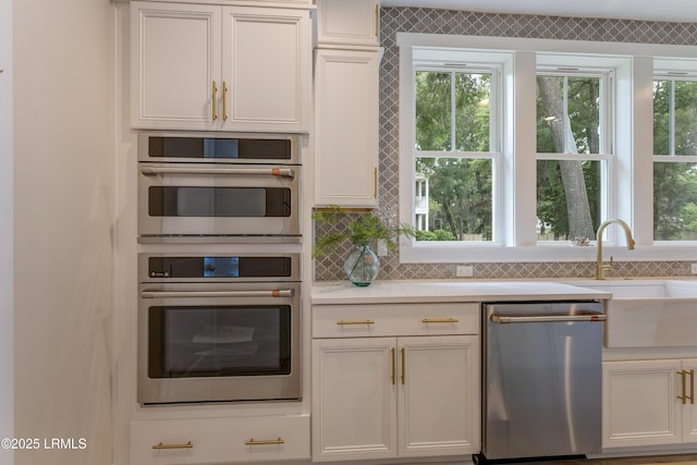 39 Wrights Point Cir, Beaufort, SC 29902 - kitchen with stainless steel appliances, backsplash, light countertops, and white cabinetry