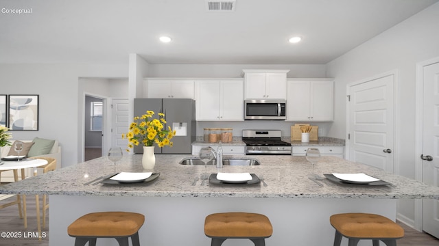 1533 Sanctum St, Ridgeland, SC 29936 - kitchen with stainless steel appliances, a breakfast bar, white cabinetry, and recessed lighting