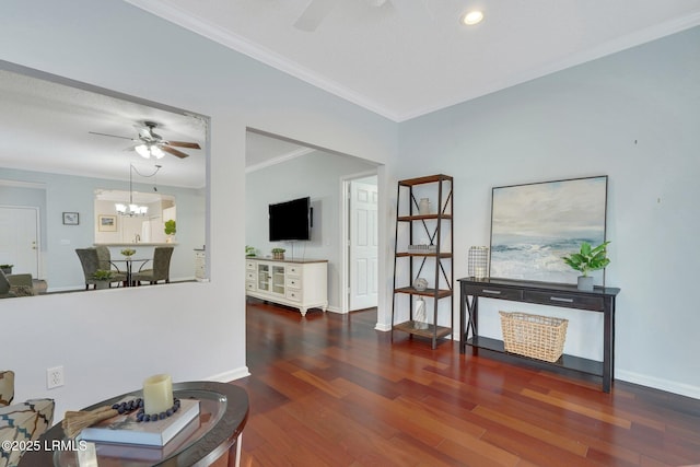 interior space with crown molding, dark hardwood / wood-style flooring, and ceiling fan with notable chandelier