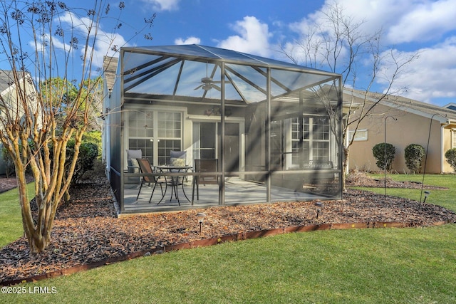 back of house with a patio area, ceiling fan, and a lawn